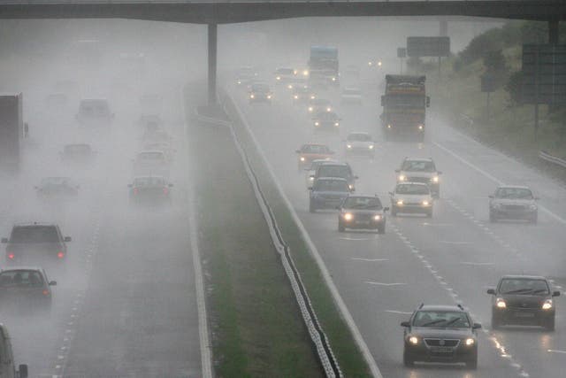 Traffic drives through rain and spray on the M5 motorway on  near Weston-Super-Mare, England