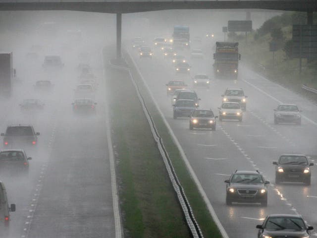 Traffic drives through rain and spray on the M5 motorway on  near Weston-Super-Mare, England