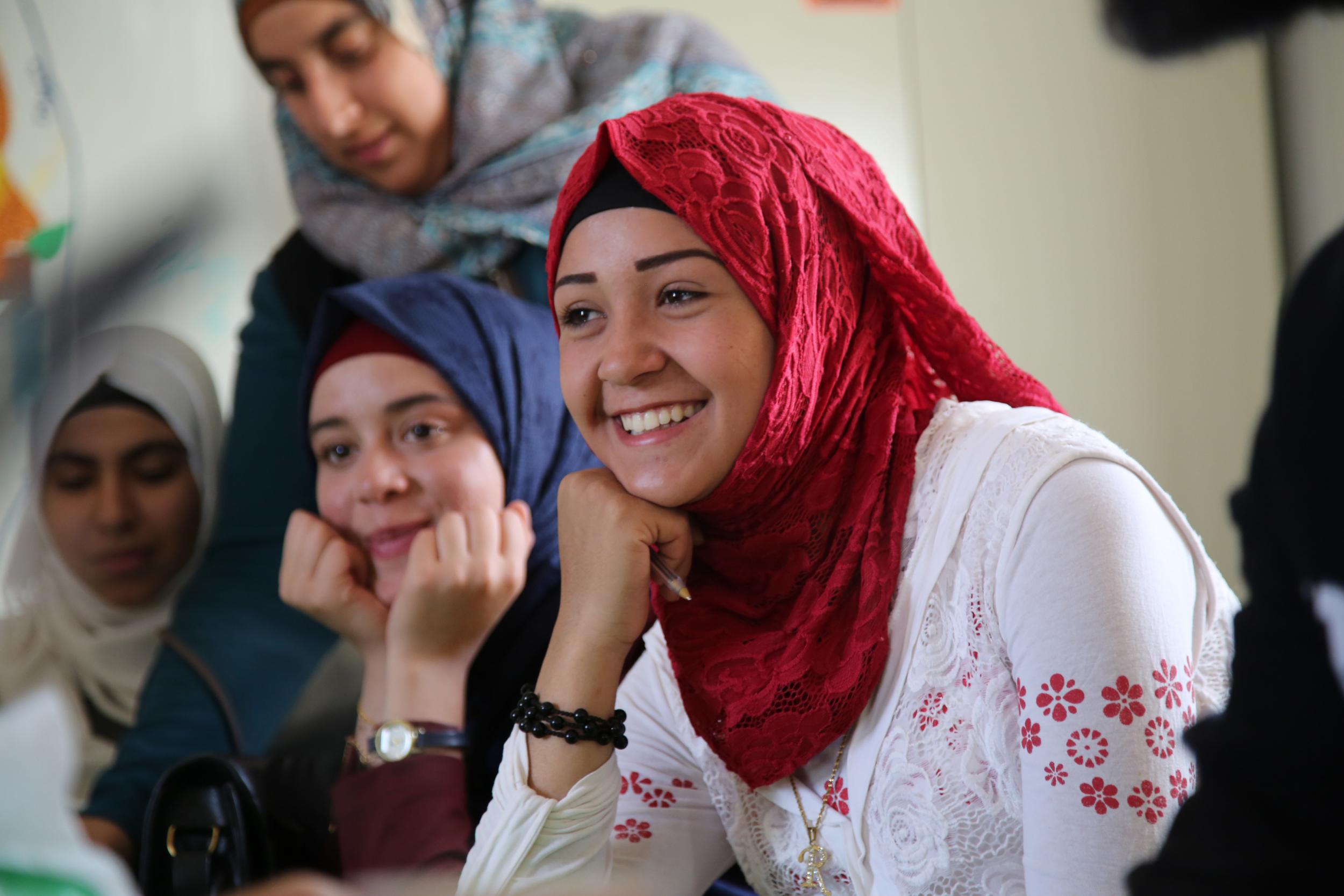 Azeh, a syrian refugee in Jordan, reacts to a video message from Hornsey school for girls in London