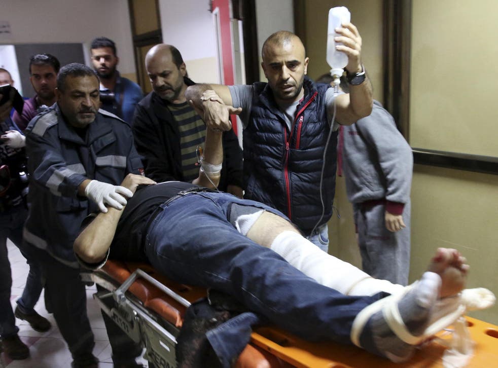 Colleagues wheel AP cameraman Rashed Rashid to a treatment room in Beit Lahiya in the northern Gaza Strip
