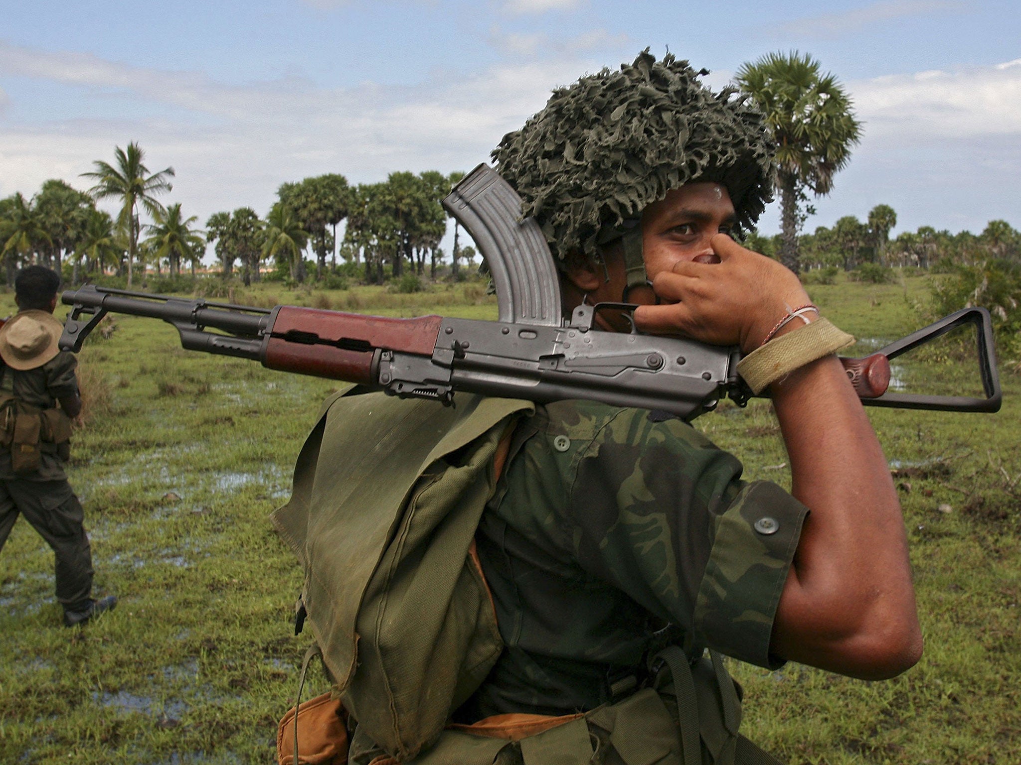 Government soldiers patrol through the countryside near Kalkudah in northeastern Sri Lanka, 2006