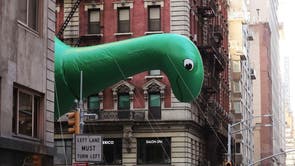 Sinclair's DINO balloon flies as the parade passes down 6th Avenue