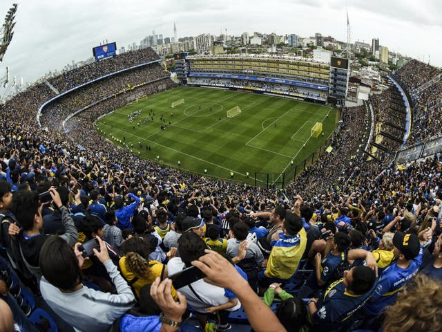 Fans of Boca Juniors cheer for their team during an open training session