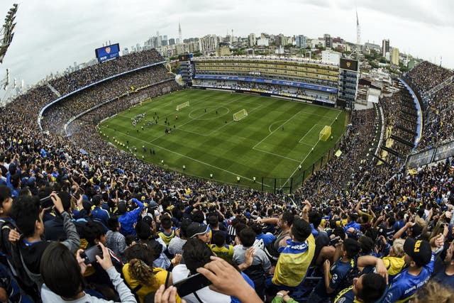 Fans of Boca Juniors cheer for their team during an open training session