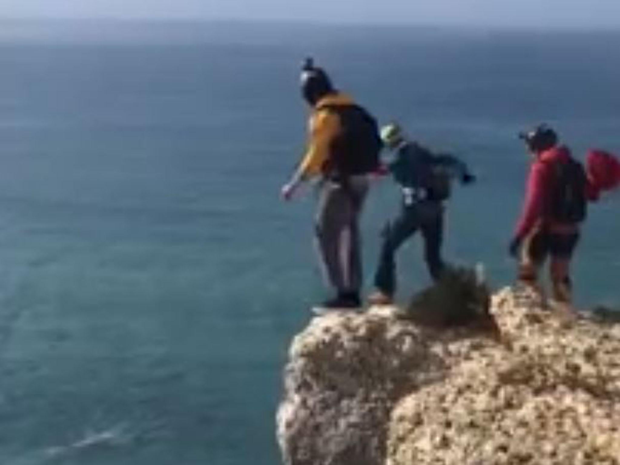 Dominic Loyen (centre, in blue) seconds before his fatal jump