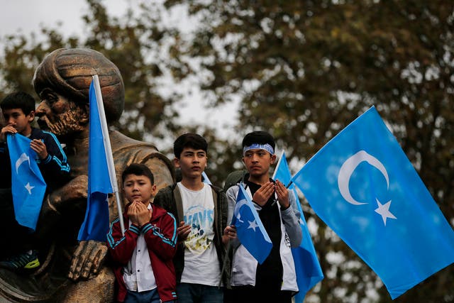 People from the Uighur community living in Turkey carrying flags of what ethnic Uighurs call 'East Turkestan', pray during a protest in Istanbul, Tuesday, Nov. 6, 2018, against what they allege is oppression by the Chinese government to Muslim Uighurs in far-western Xinjiang province.