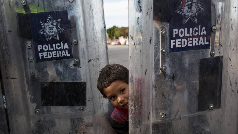 migrant-caravan-police-child.jpg
