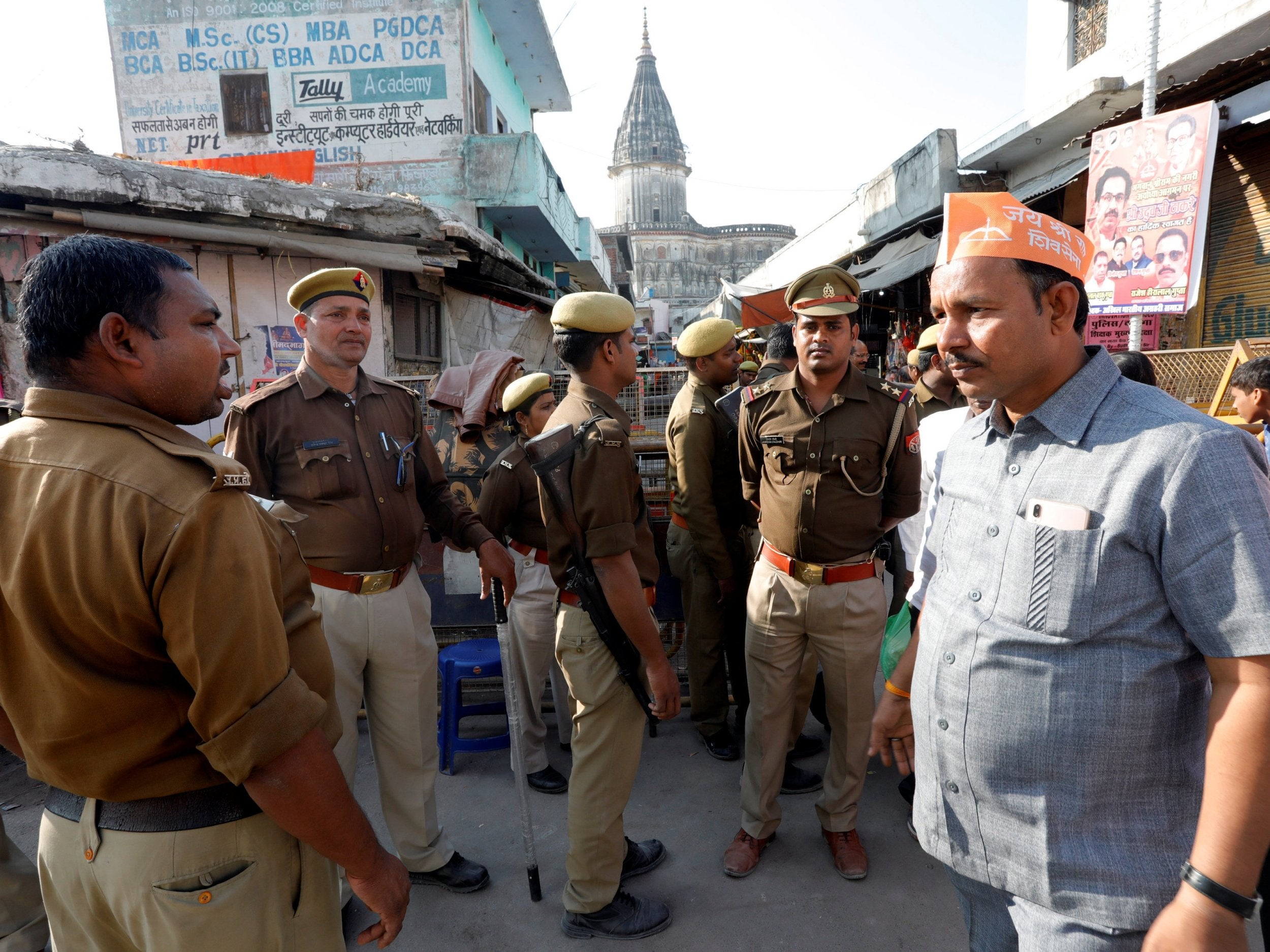 Police stand guard in an Ayodhya street ahead of Sunday’s protests