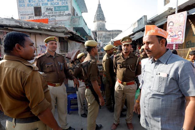 Police stand guard in an Ayodhya street ahead of Sunday’s protests