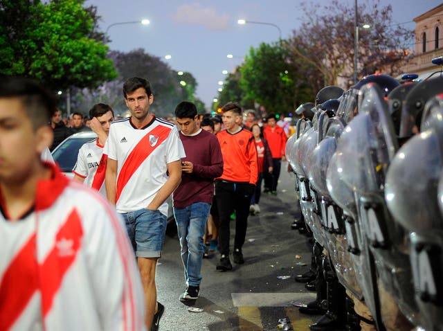 Supporters of River Plate leave the Monumental stadium in Buenos Aires after authorities postponed the match