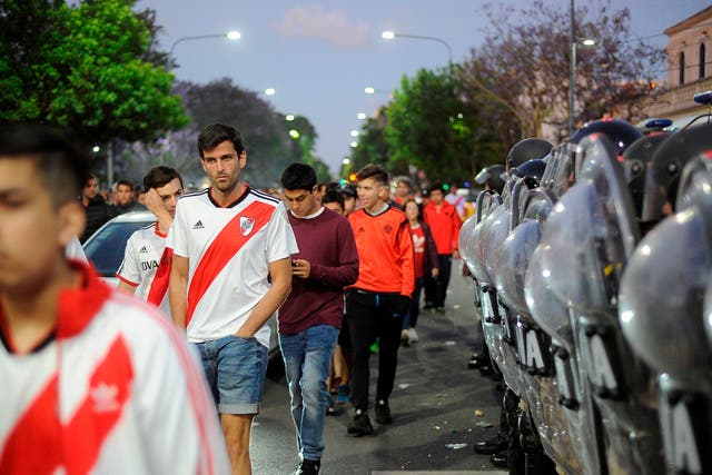 Supporters of River Plate leave the Monumental stadium in Buenos Aires after authorities postponed the match