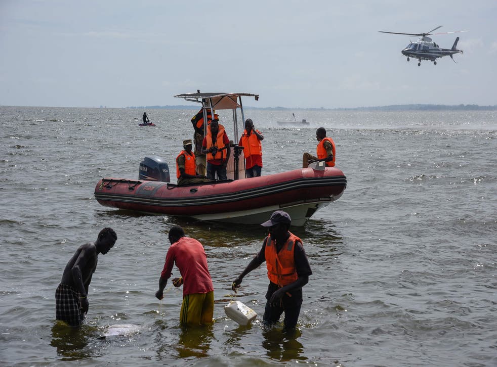 Rescuers search for victims the day after the cruise boat capsized on Lake Victoria