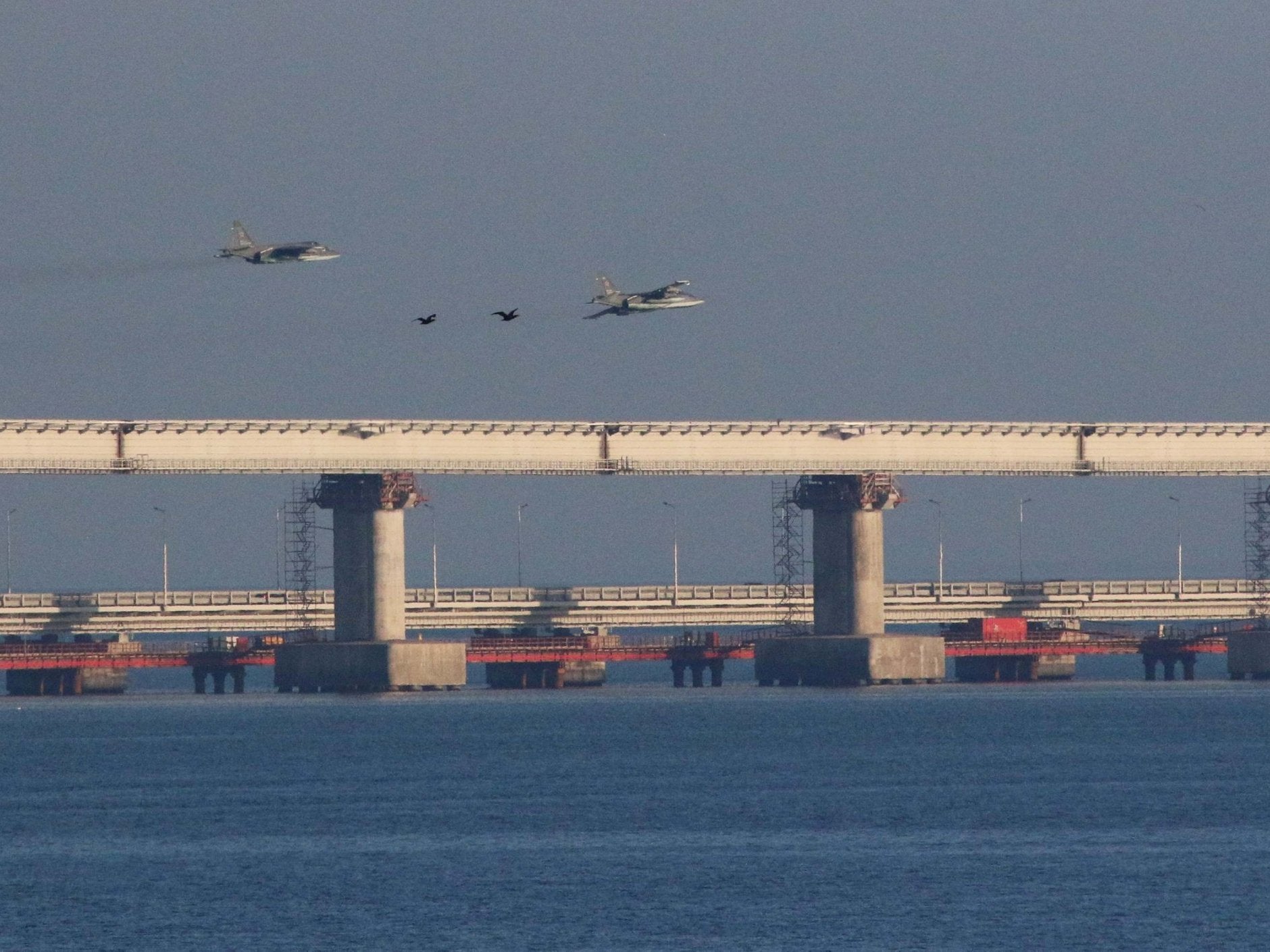 Russian jet fighters fly over a bridge connecting the Russian mainland with the Crimean peninsula