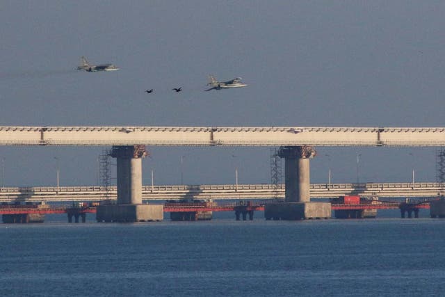 <p>Russian jet fighters fly over a bridge connecting the Russian mainland with the Crimean peninsula</p>