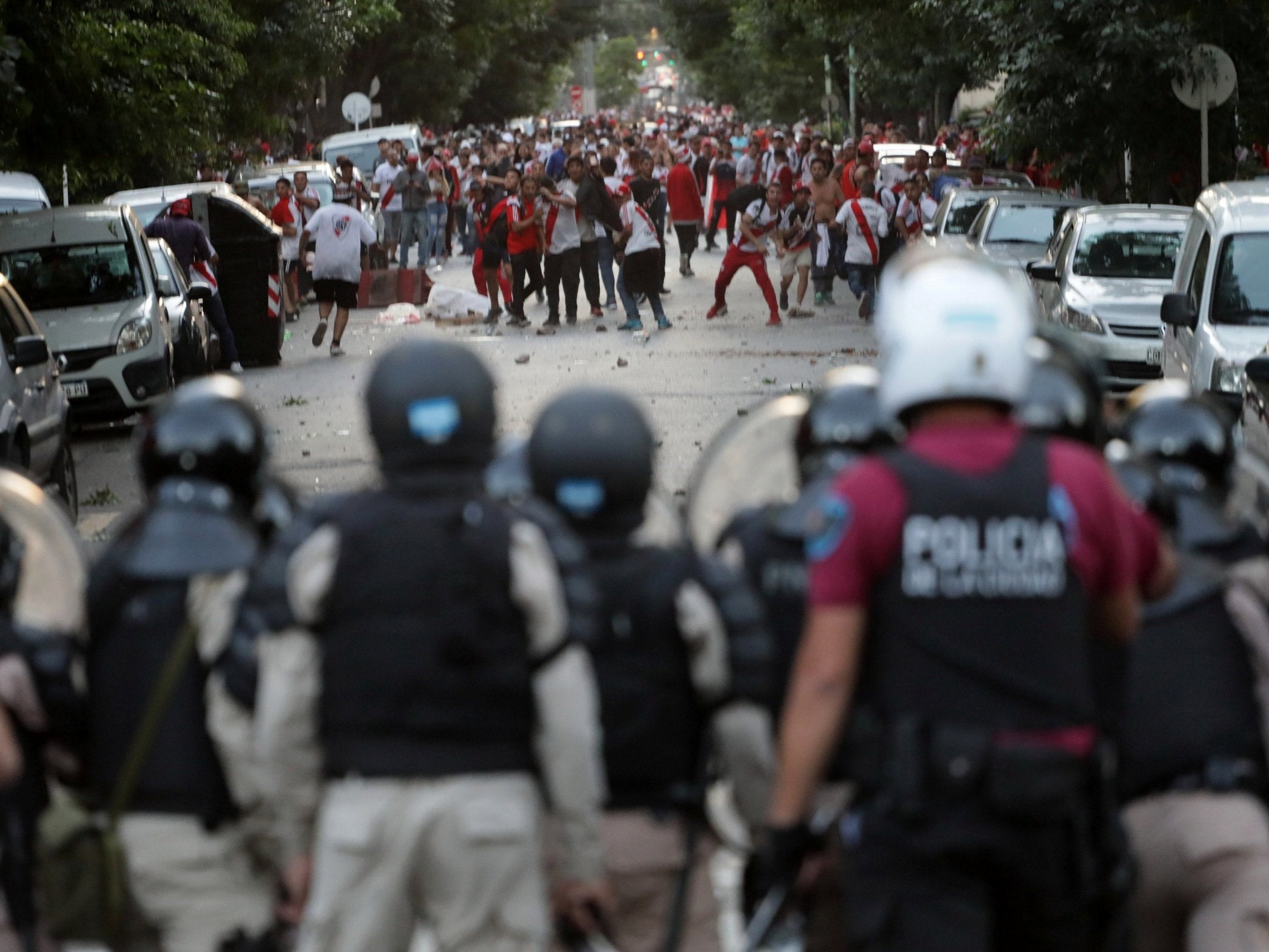 River Plate's fans clash with riot police after the match was postponed