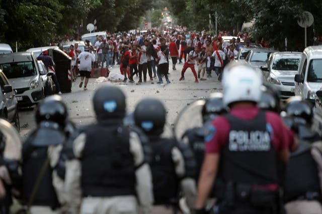 River Plate's fans clash with riot police after the match was postponed