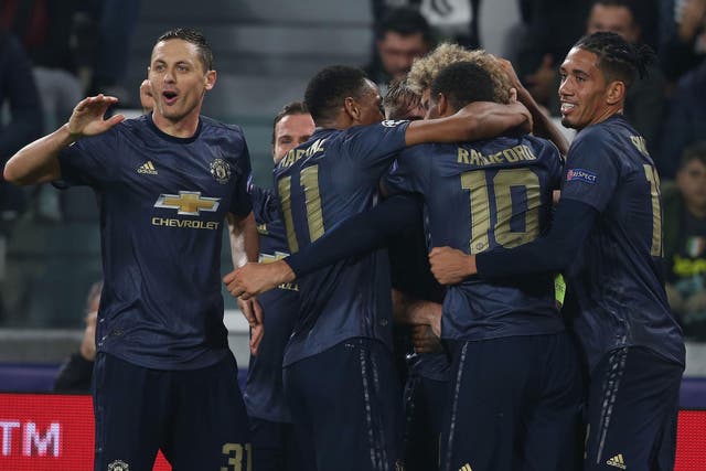Manchester United celebrate their surprise win against Juventus in Turin