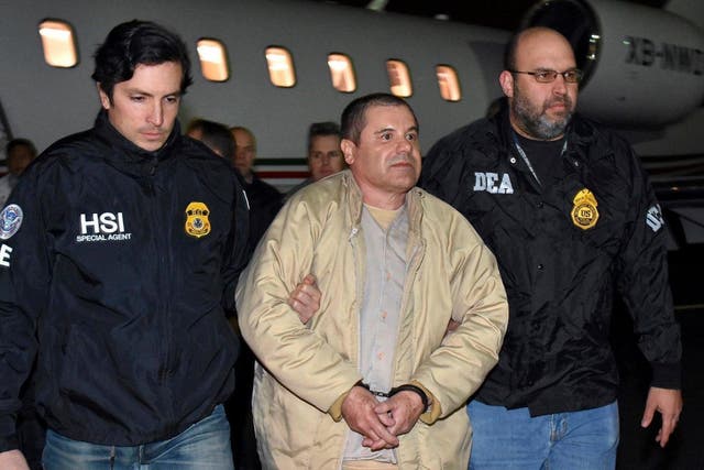 Authorities escort Mexican kingpin Joaquin 'El Chapo' Guzman, centre, from a plane to a waiting fleet of SUVs at Long Island MacArthur Airport, New York