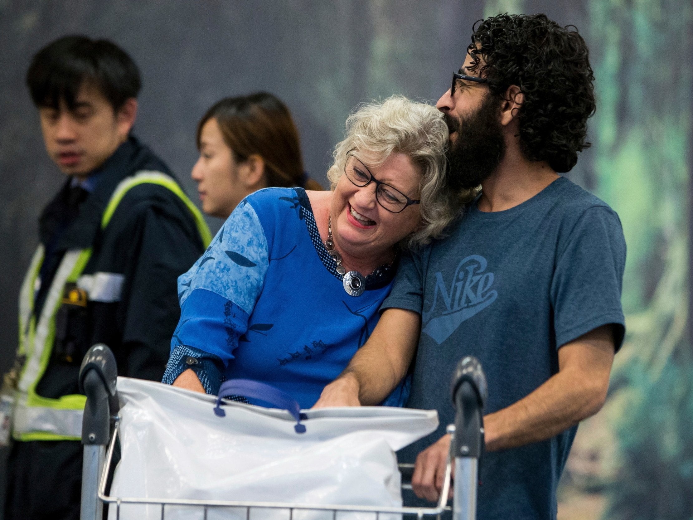 Hassan Al Kontar hugs Laurie Cooper after arriving at an airport in Vancouver, British Columbia, on Monday