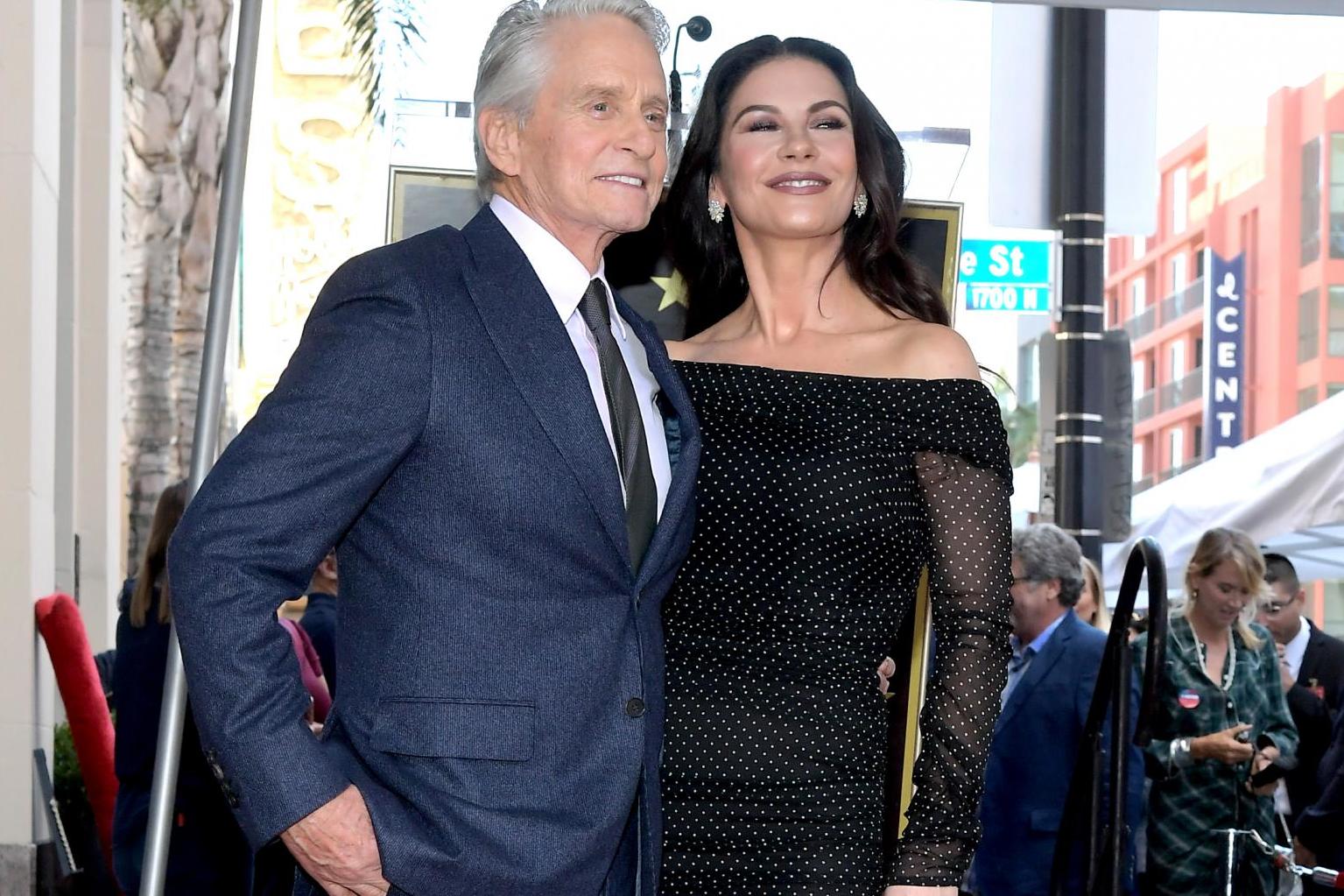 Michael Douglas and Catherine Zeta-Jones pose for a photo at the Hollywood Walk of Fame Ceremony honoring Michael Douglas on Hollywood Boulevard on 6 November, 2018 in Hollywood, California.