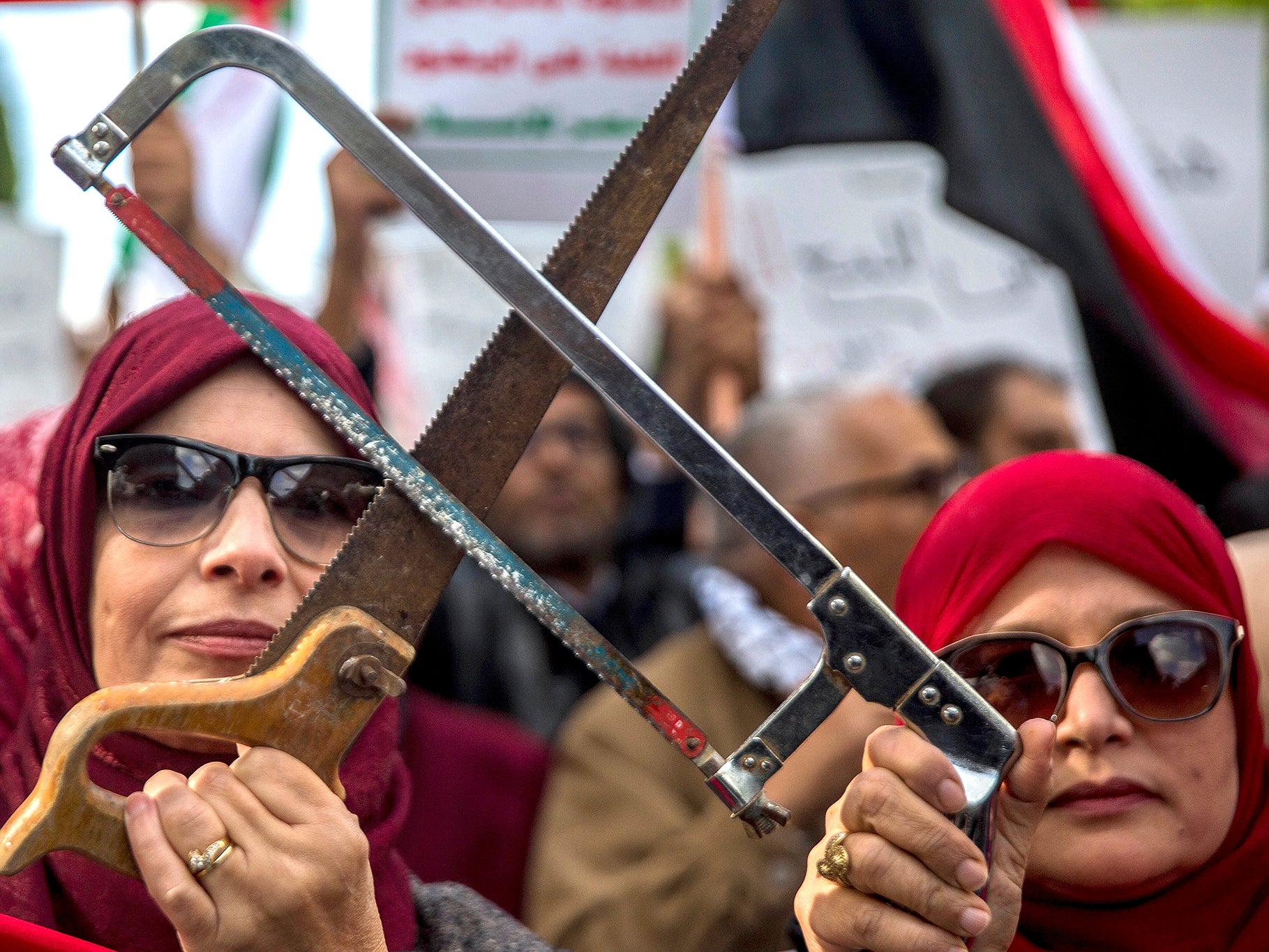 Tunisians demonstrate with saws in Tunis, as the Saudi crown prince arrived in the capital