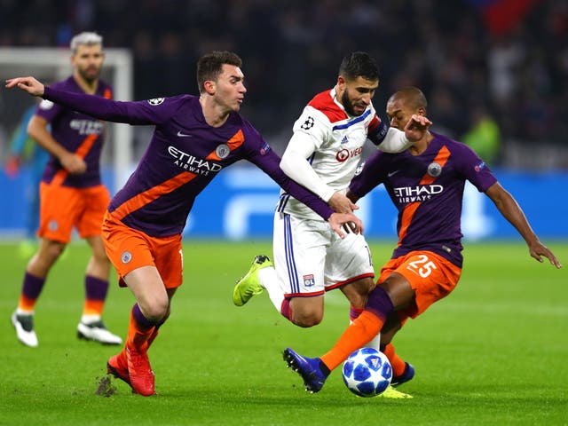Manchester City defenders try to stop Nabil Fekir