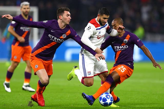 Manchester City defenders try to stop Nabil Fekir