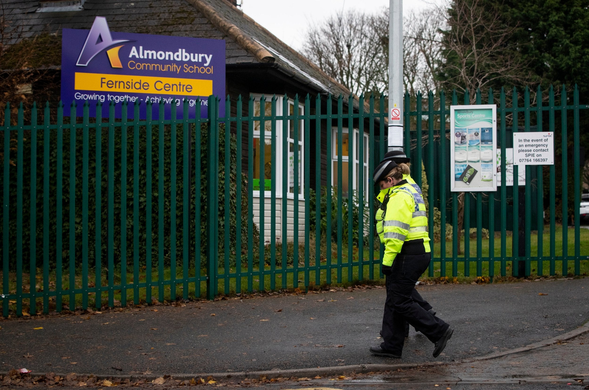 Police Community Support Officers walk past Almondbury Community School in Huddersfield