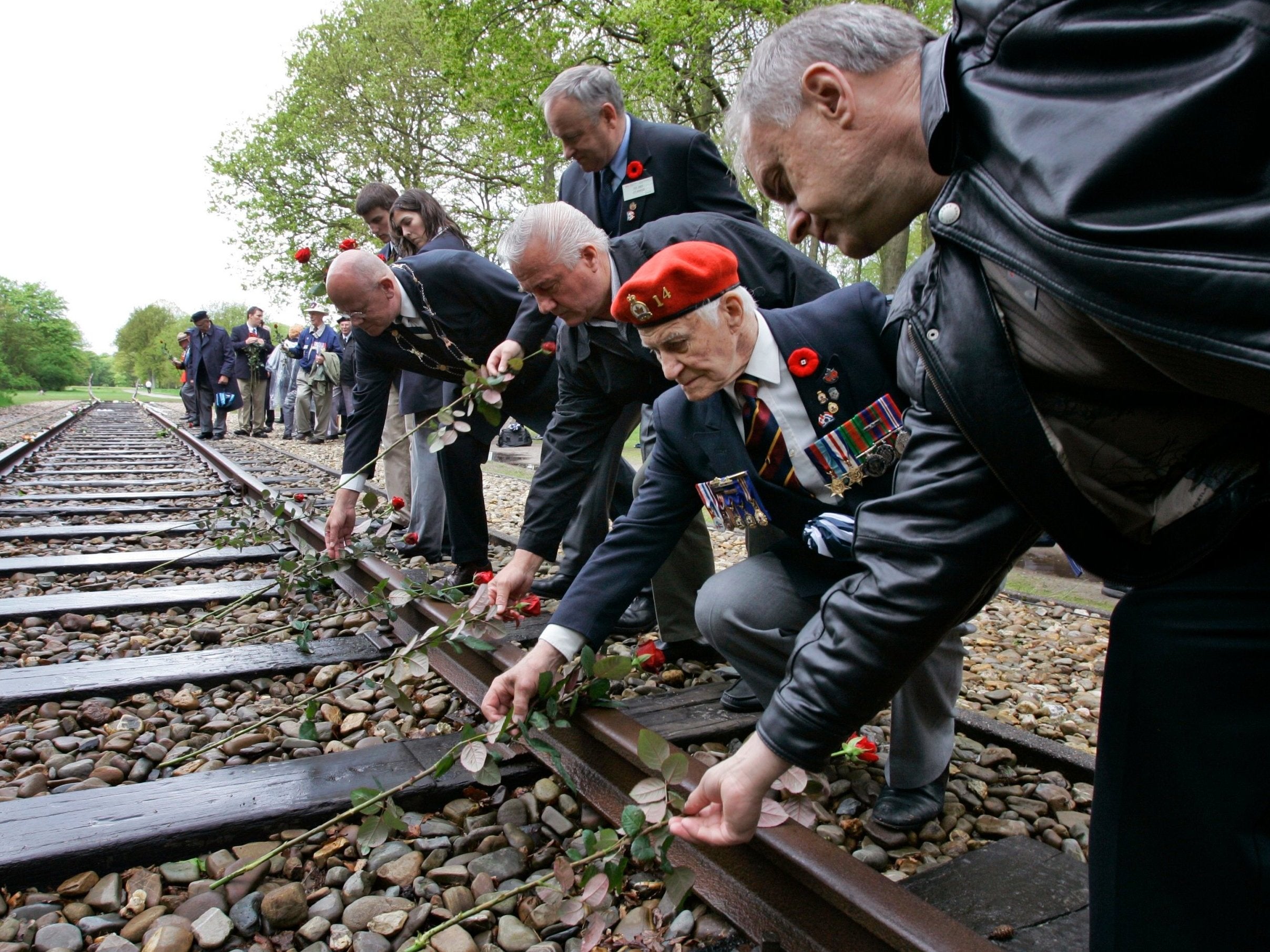 Veterans put roses on the railroad tracks at the Westerbork former concentration camp