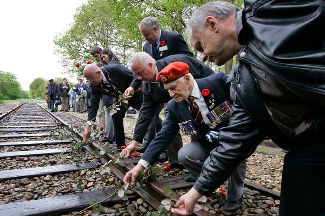 Veterans put roses on the railroad tracks at the Westerbork former concentration camp