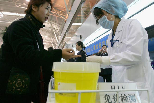 A Chinese passenger receives a free HIV check at Beijing International Airport