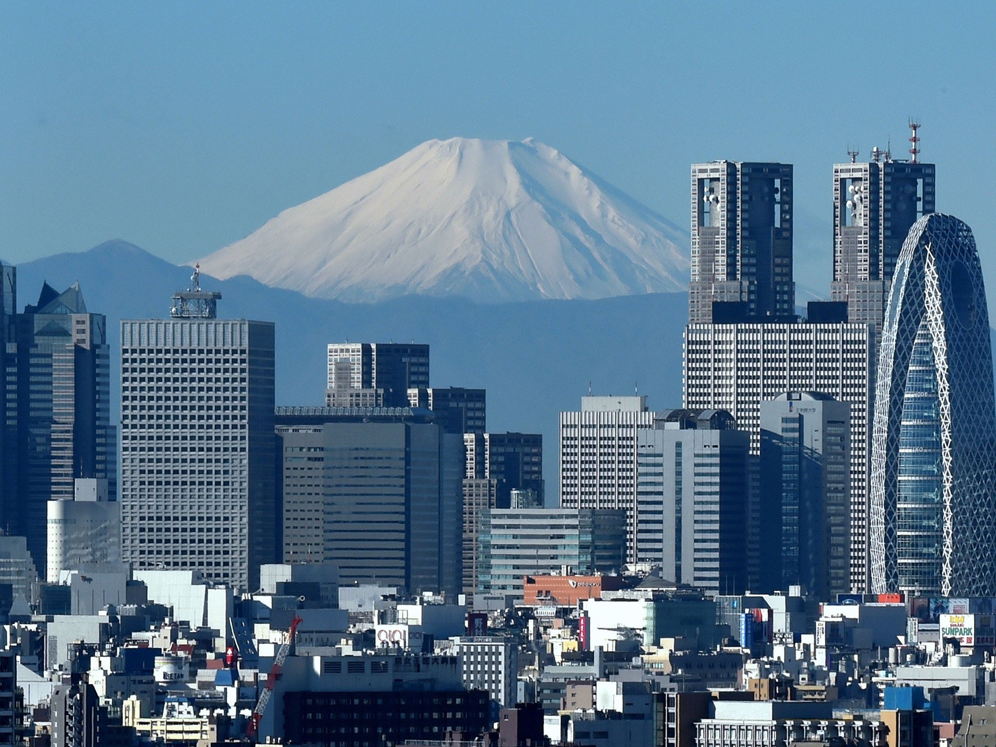 The Shinjuku commercial district in Tokyo: higher-skilled workers are to be offered renewable visas, under new proposals