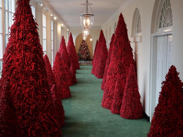 More than 40 red topiary trees line the East colonnade as part of Christmas decorations at the White House on 26 November 2018