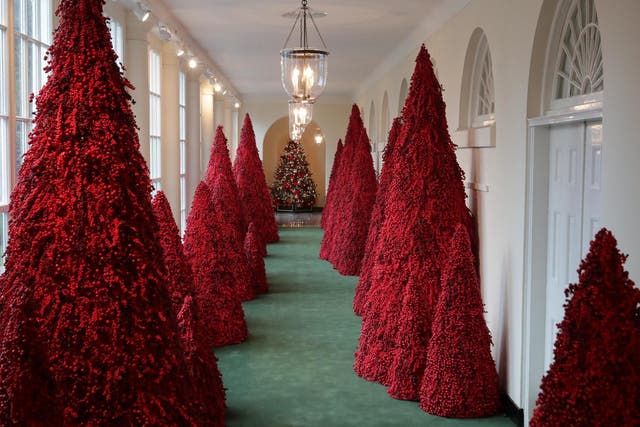 More than 40 red topiary trees line the East colonnade as part of Christmas decorations at the White House on 26 November 2018