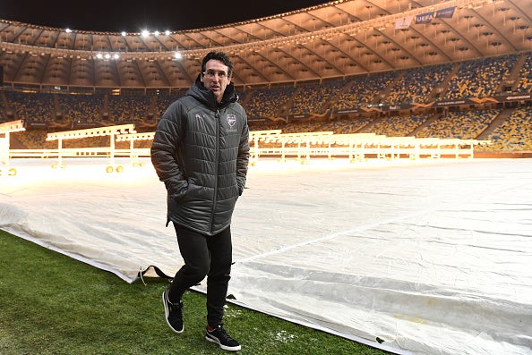 Unai Emery inspects the pitch at the stadium in Poltava before the match was moved