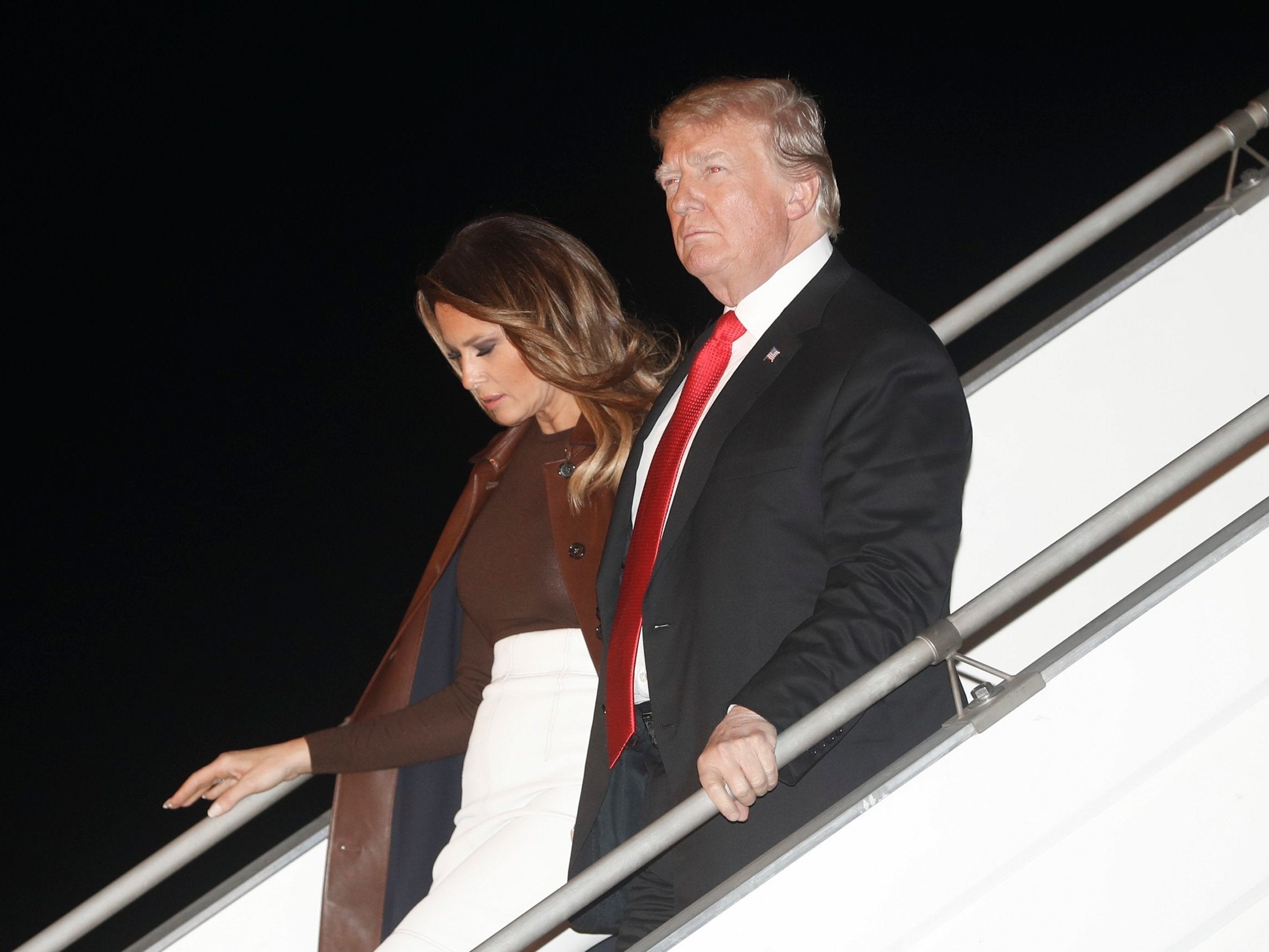 President Donald Trump and first lady Melania Trump walk from Air Force One