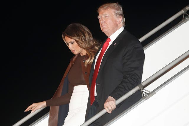President Donald Trump and first lady Melania Trump walk from Air Force One