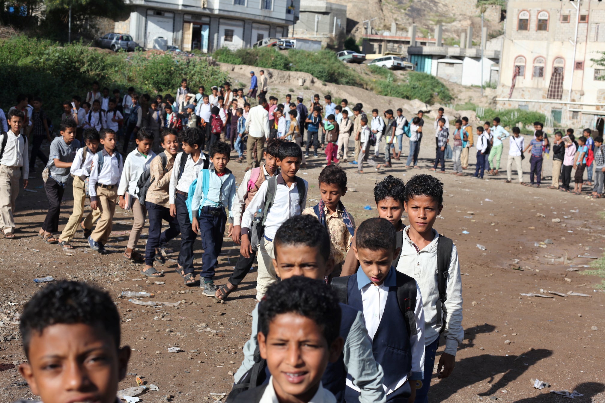 Yemeni students walk to classes at their teacher’s house, which operates as a makeshift free school in the city of Taiz