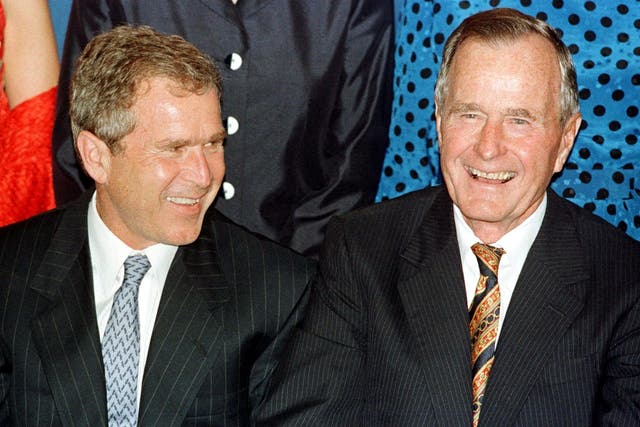 File photo dated 10 June, 1999 shows Texas Governor and presidential hopeful George W Bush laughing with his father, former US President George Bush