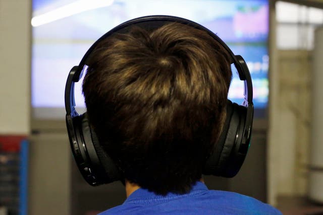 Henry Hailey, 10, plays one of the online Fortnite game in the early morning hours in the basement of his Chicago home
