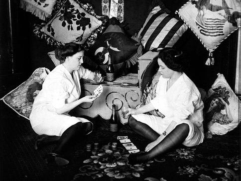 Two women play cards in Storyville, circa 1912. After two decades of lucrative operations, the area’s brothels were forced to close as a result of intense political pressure exerted by the US military – especially the Navy