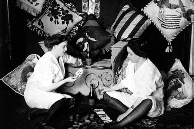 Two women play cards in Storyville, circa 1912. After two decades of lucrative operations, the area’s brothels were forced to close as a result of intense political pressure exerted by the US military – especially the Navy