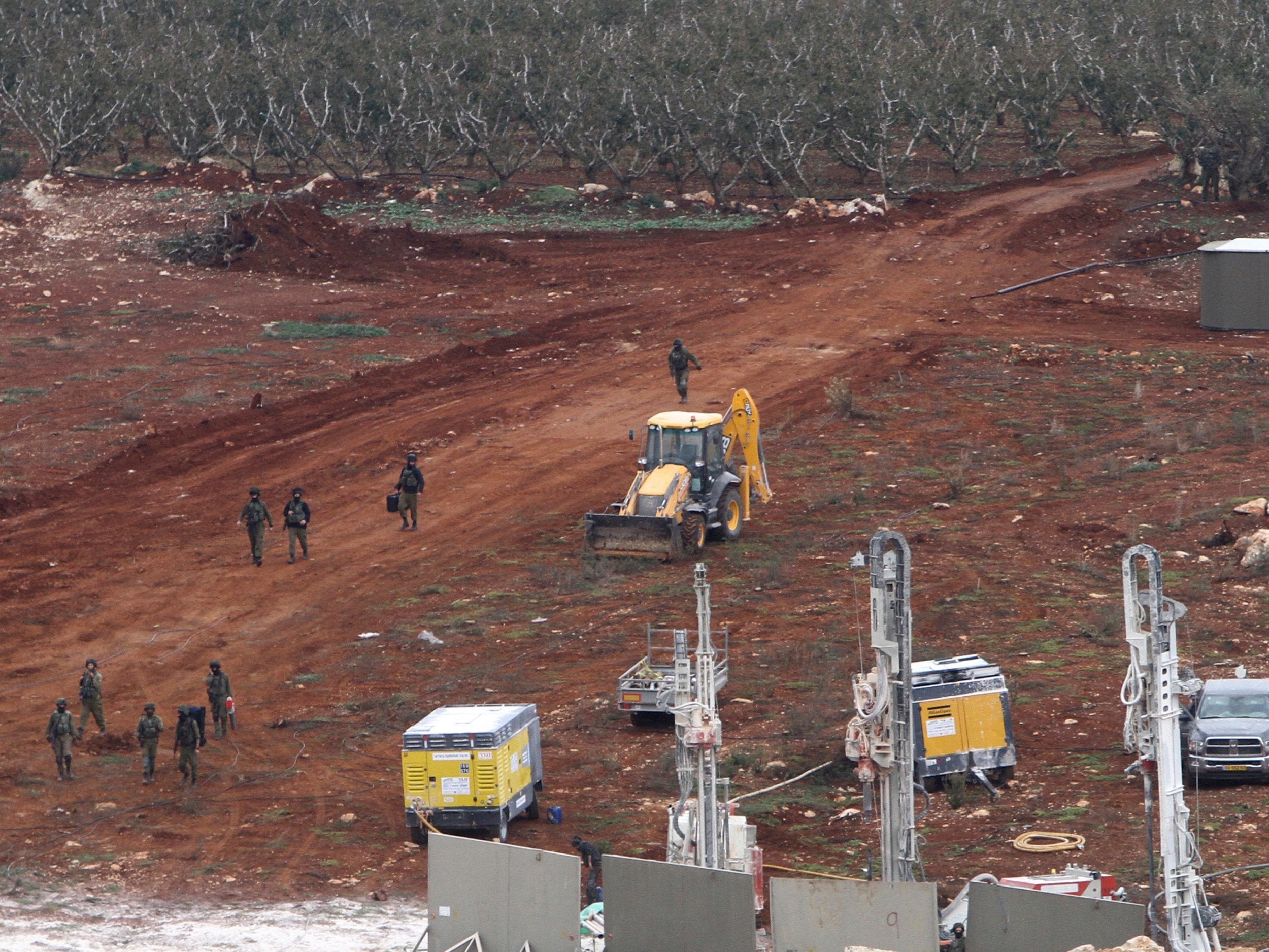 An Israeli military digger works on the Lebanese-Israeli border next to a wall that was built by Israel in the southern village of Kafr Kila, Lebanon. The Israeli military launched an operation on Tuesday to ‘expose and thwart’ tunnels it says were built by the Hezbollah militant group that stretch from Lebanon into northern Israel