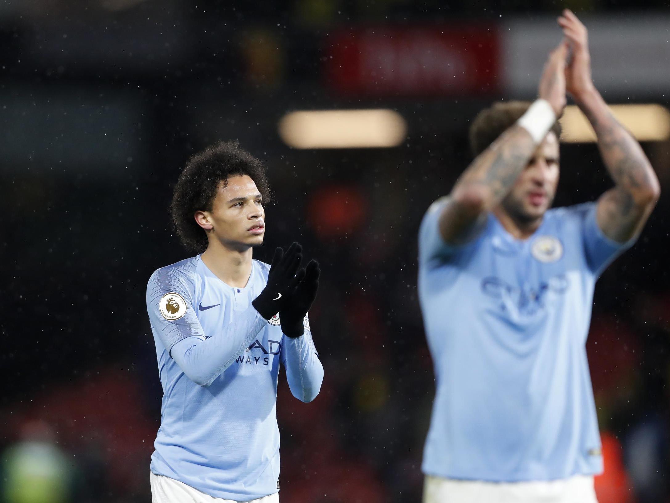 Leroy Sane and Kyle Walker celebrate after securing victory at Vicarage Road