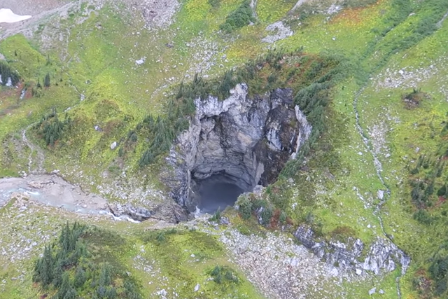 The enormous cave discovered in British Columbia seen from a helicopter