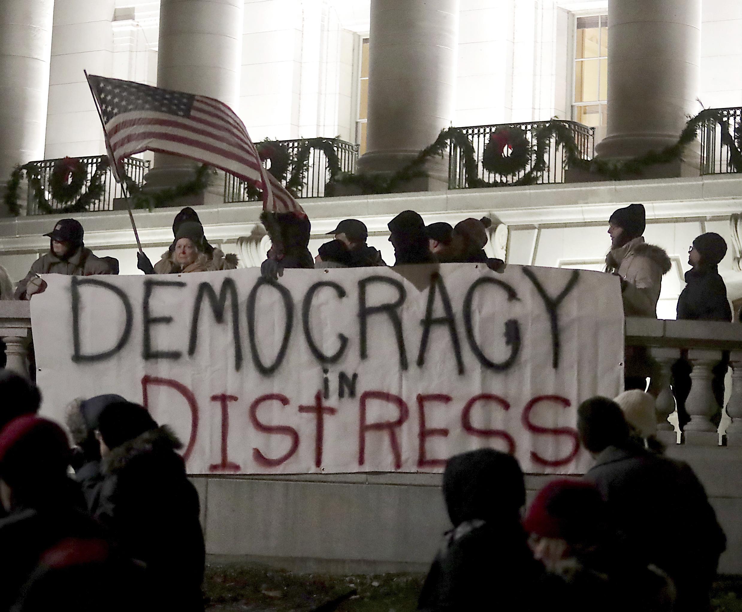 Opponents of an extraordinary session bill submitted by Wisconsin Republican legislators gather for a rally outside the Wisconsin state Capitol in Madison, Wis., Monday, 3 December 2018.