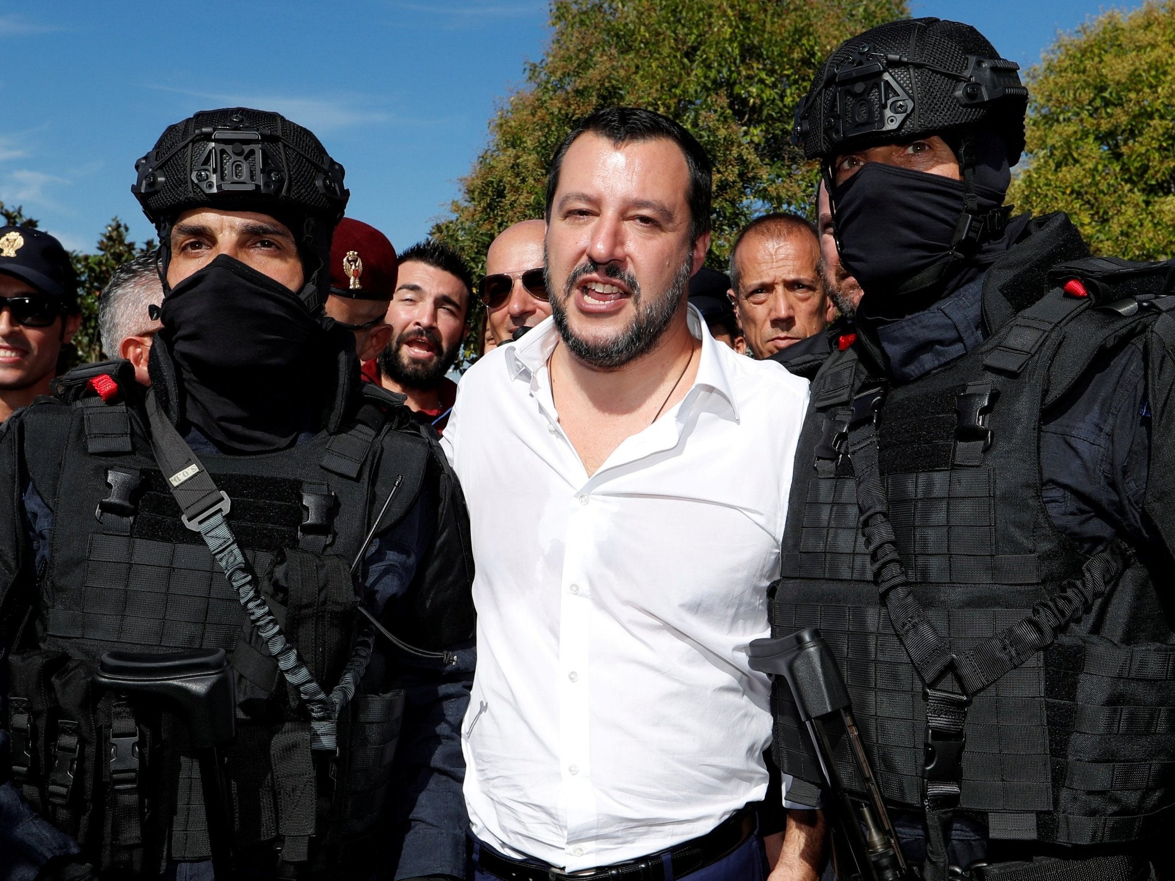 Italian interior minister Matteo Salvini poses with two members of the Central Security Operations Service, a swat team of the state police