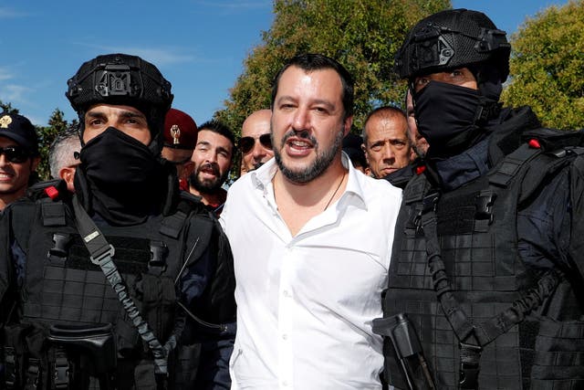Italian interior minister Matteo Salvini poses with two members of the Central Security Operations Service, a swat team of the state police