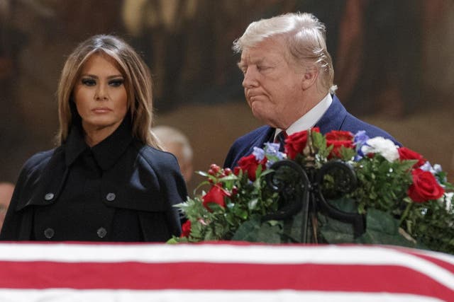 Donald Trump and wife Melania visit George HW Bush's casket in Washington on 3 December