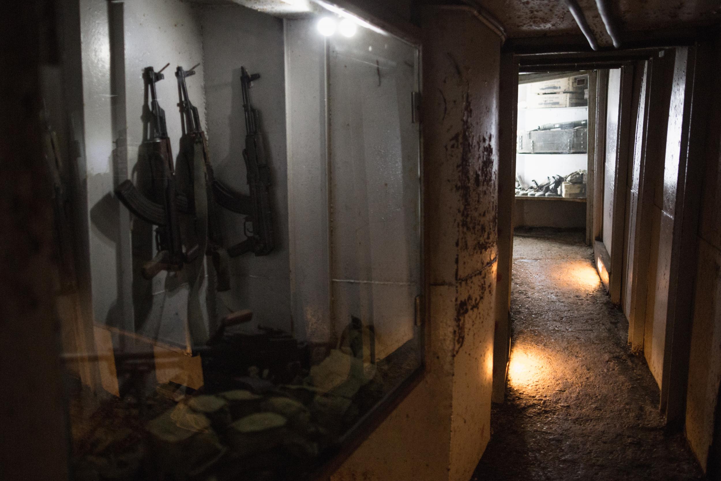 Assault rifles are displayed in the museum’s tunnel bunker complex (Sam Tarling/The Independent)